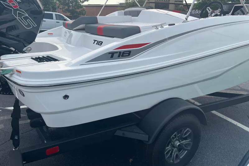 Slide: The Image of 2026 Tahoe T18 boat on trailer, featuring sleek white design and modern detailing. - 2