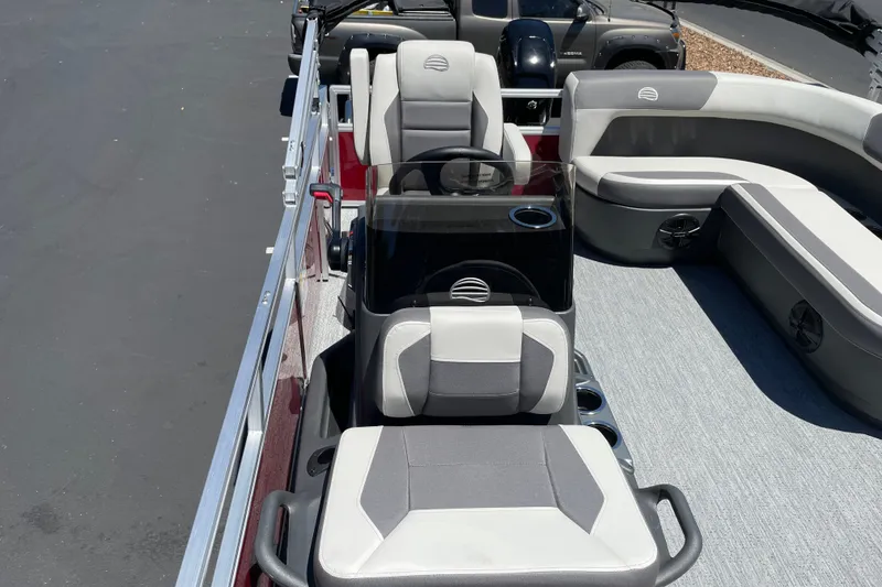 Slide: The Image of 2026 Sun Tracker Bass Buggy 16 XL Select pontoon boat interior with seating and steering console. - 17