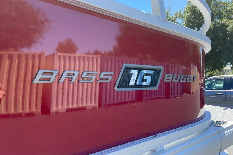 Slide: The Image of 2026 Sun Tracker Bass Buggy 16 XL Select, red exterior with logo detail. - 30
