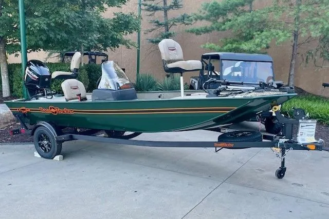 Slide: The Image of 2026 Tracker Bass Tracker Classic Limited boat on trailer, parked outdoors. - 5