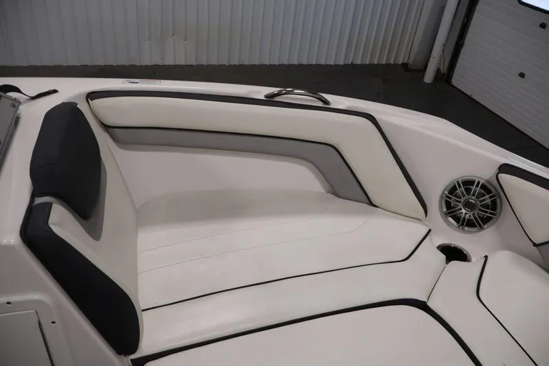 Slide: The Image of 2016 Yamaha Boats SX192 interior seating with white upholstery and speaker detail. - 15
