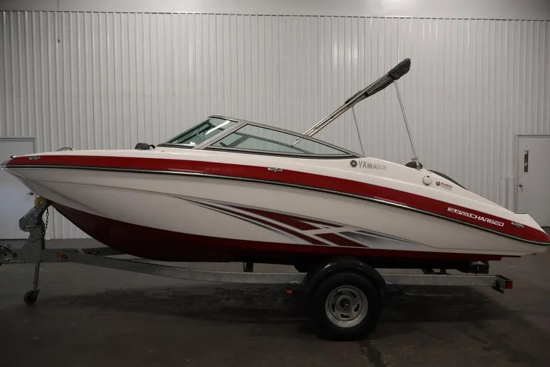 Slide: The Image of 2016 Yamaha Boats SX192, red and white, on trailer in indoor setting. - 17