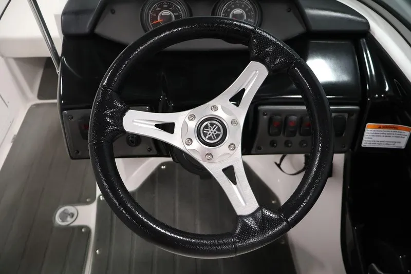 Slide: The Image of Steering wheel of a 2016 Yamaha Boats SX192, featuring dashboard controls. - 18