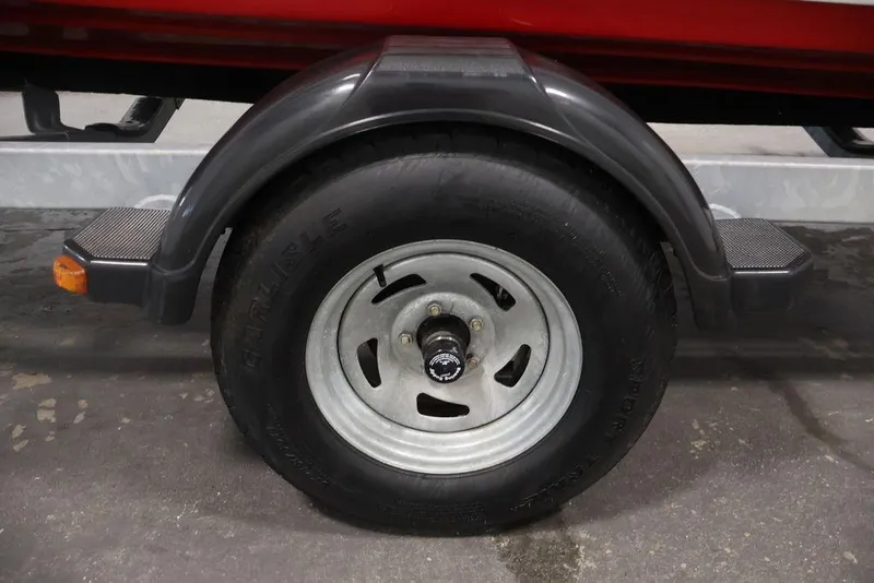 Slide: The Image of 2016 Yamaha Boats SX192 trailer wheel with black tire and metal rim. - 39