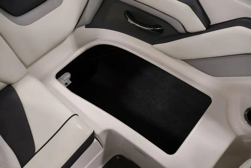 Slide: The Image of 2016 Yamaha SX192 boat interior storage compartment with cushioned seating. - 44
