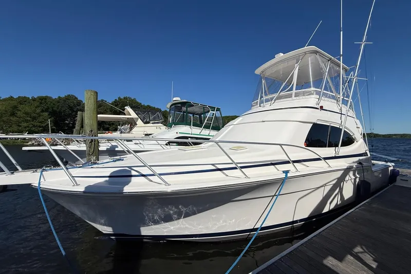 Slide: The Image of 2002 Bertram 390 Convertible yacht docked on a sunny day. - 2