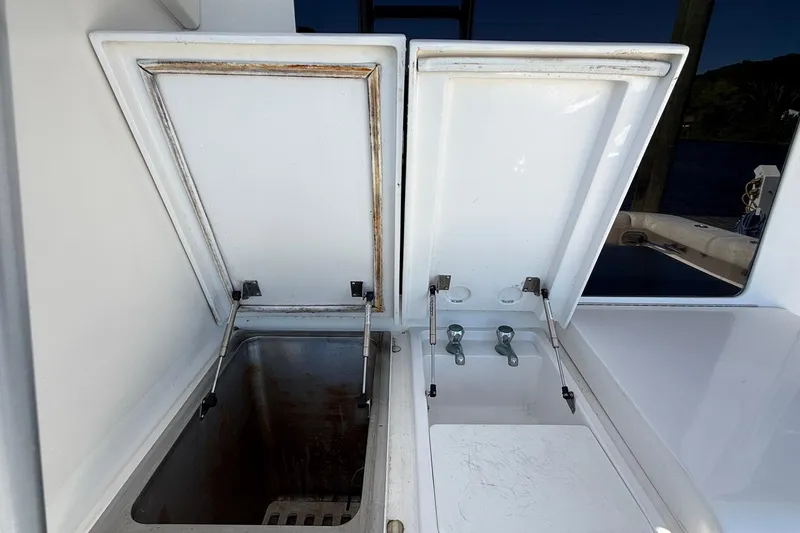 Slide: The Image of Open storage compartments on a 2002 Bertram 390 Convertible boat deck. - 26