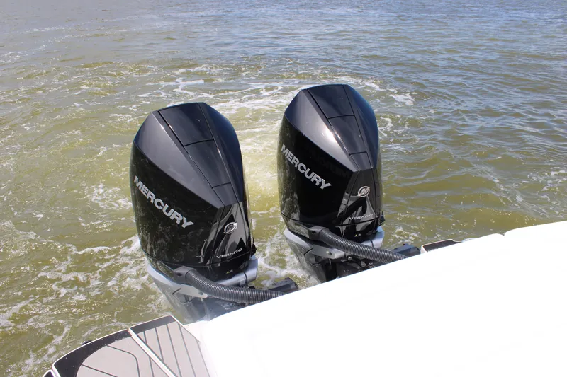 Slide: The Image of Two Mercury outboard engines on a Sea Ray SLX 280 boat in calm water. - 49