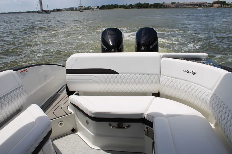 Slide: The Image of The image shows the stern of a 2026 Sea Ray SLX 280 Outboard with white cushioned seats and two outboard engines on a body of water. - 46