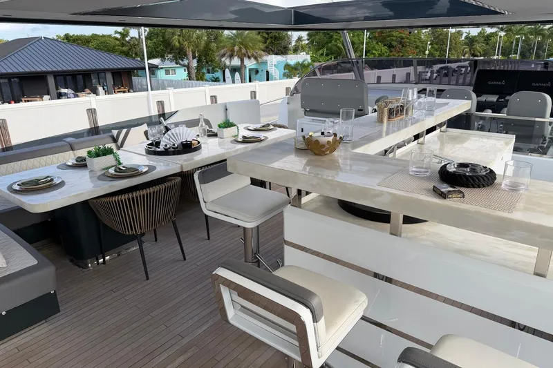 Slide: The Image of Luxurious 2024 Sirena 88 yacht deck with elegant dining setup and modern seating. - 28