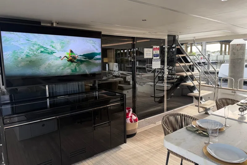 Slide: The Image of Luxurious 2024 Sirena 88 yacht interior with dining area and large TV screen. - 21