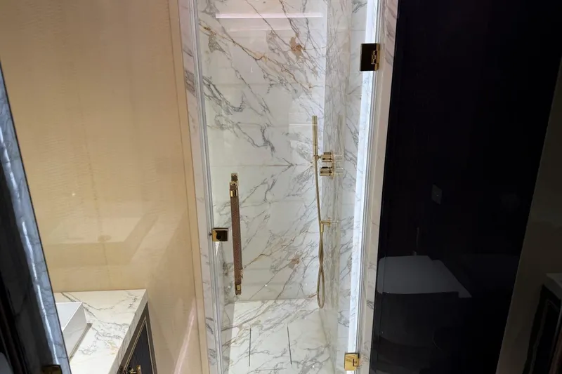 Slide: The Image of Luxurious marble shower with gold fixtures in 2024 Sirena 88 yacht bathroom. - 80