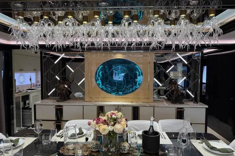 Slide: The Image of Luxurious dining area on 2024 Sirena 88 yacht with elegant decor and glass chandelier. - 138