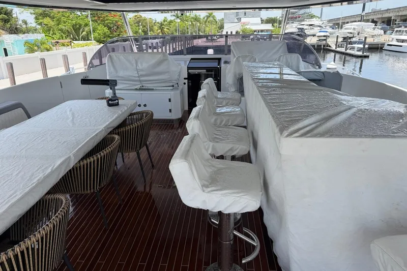 Slide: The Image of Luxurious 2024 Sirena 88 yacht deck with bar, seating, and marina view. - 55