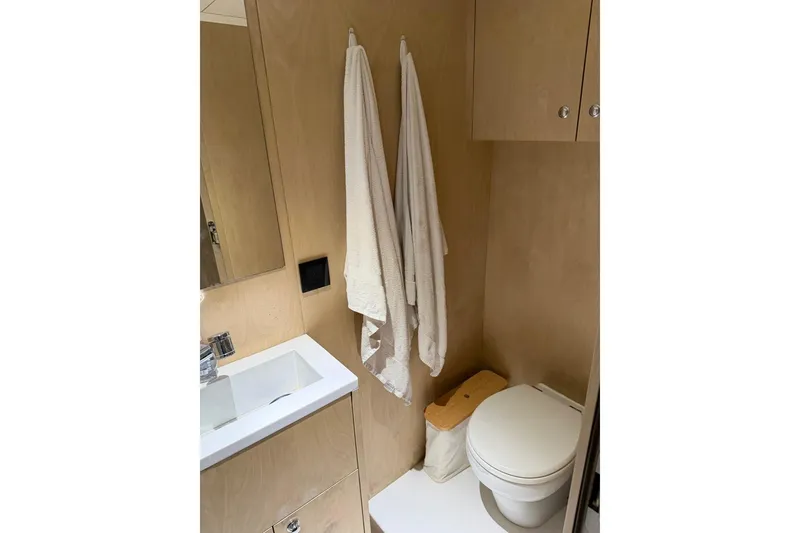 Slide: The Image of Modern bathroom in 2024 Sirena 88 yacht with sink, toilet, and towels. - 140