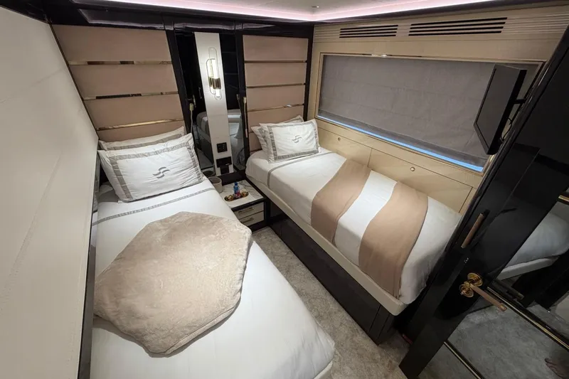 Slide: The Image of Luxurious twin bedroom interior of 2024 Sirena 88 yacht, featuring elegant bedding and modern design. - 79