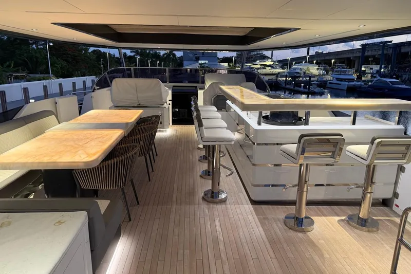 Slide: The Image of Luxurious 2024 Sirena 88 yacht deck with elegant seating and bar area at sunset. - 16