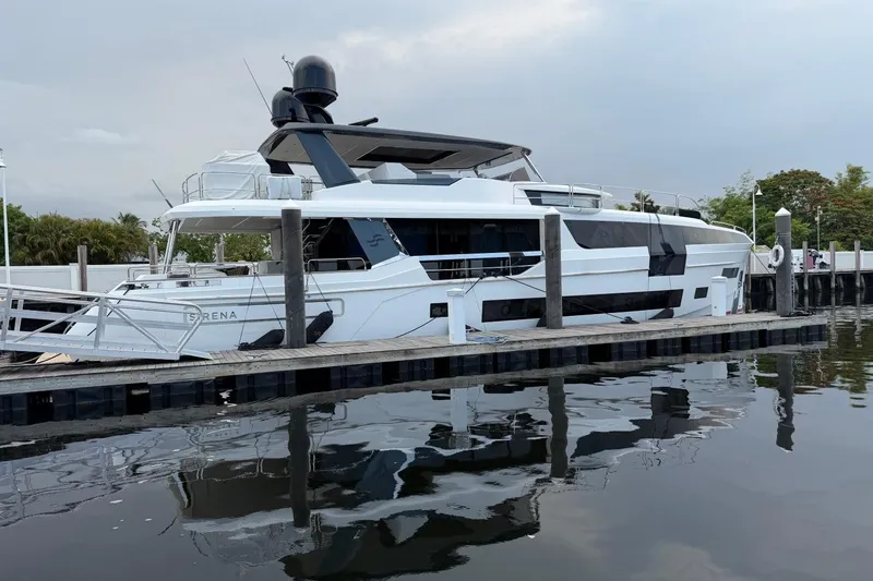 Slide: The Image of Luxury 2024 Sirena 88 yacht docked at marina, reflecting on calm water. - 3