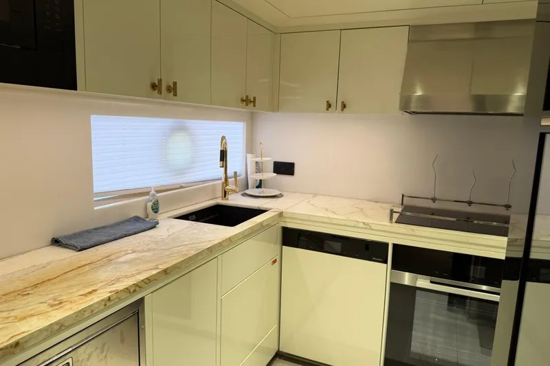 Slide: The Image of Modern kitchen interior on 2024 Sirena 88 yacht with marble countertops and sleek appliances. - 150