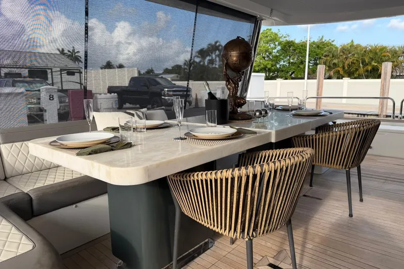 Slide: The Image of Luxurious dining setup on 2024 Sirena 88 yacht with elegant tableware and stylish chairs. - 17