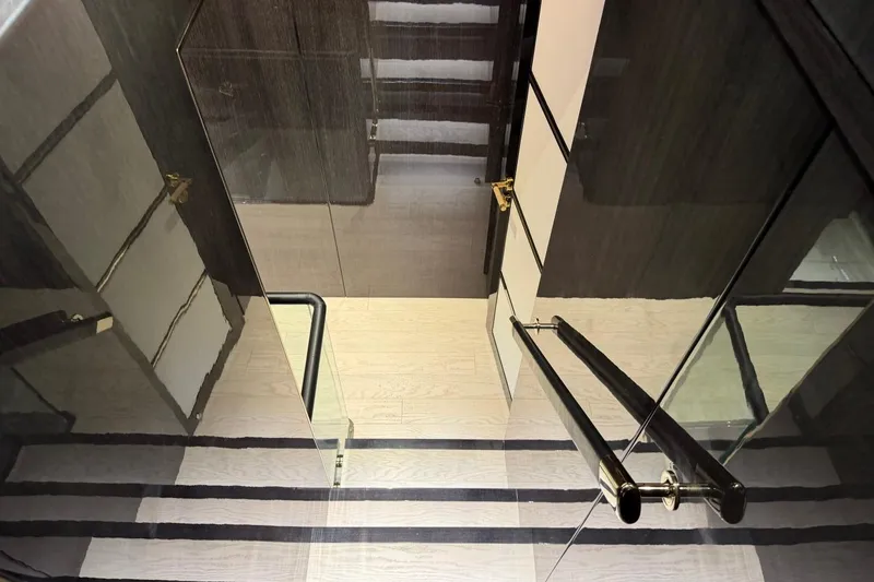 Slide: The Image of Luxurious interior staircase of 2024 Sirena 88 yacht with sleek glass and wood design. - 136