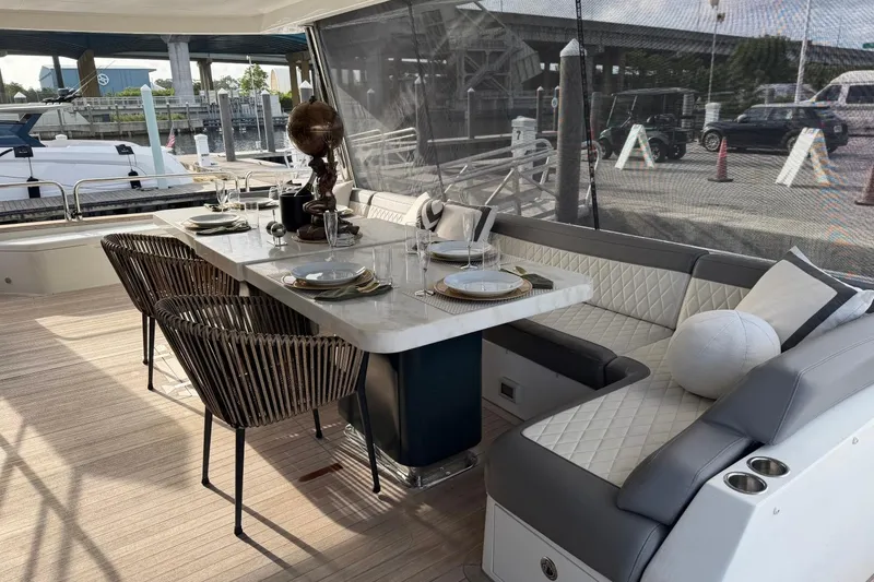 Slide: The Image of Luxurious dining area on 2024 Sirena 88 yacht, featuring elegant seating and tableware. - 18