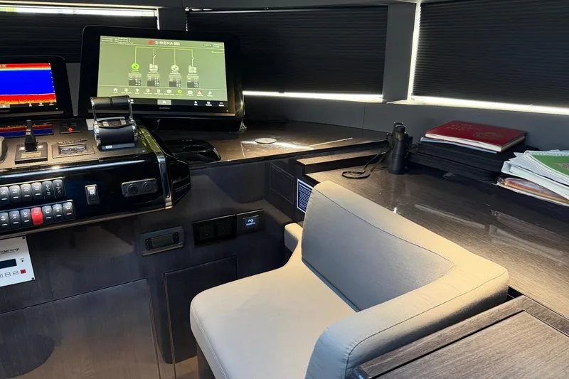 Slide: The Image of Control panel of 2024 Sirena 88 yacht with modern navigation screens and comfortable seating. - 94