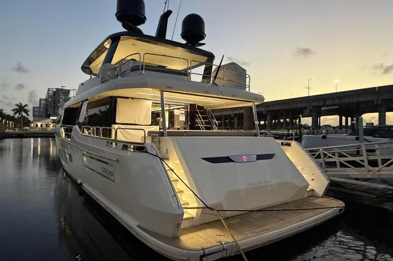 Slide: The Image of Luxury 2024 Sirena 88 yacht docked at sunset, illuminated and elegant. - 66
