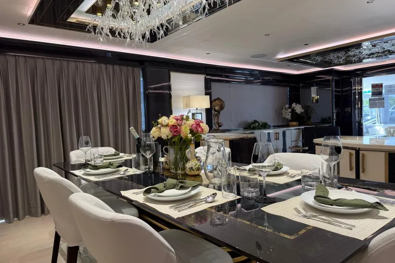 Slide: The Image of Luxurious dining area on 2024 Sirena 88 yacht, elegantly set table with floral centerpiece. - 100