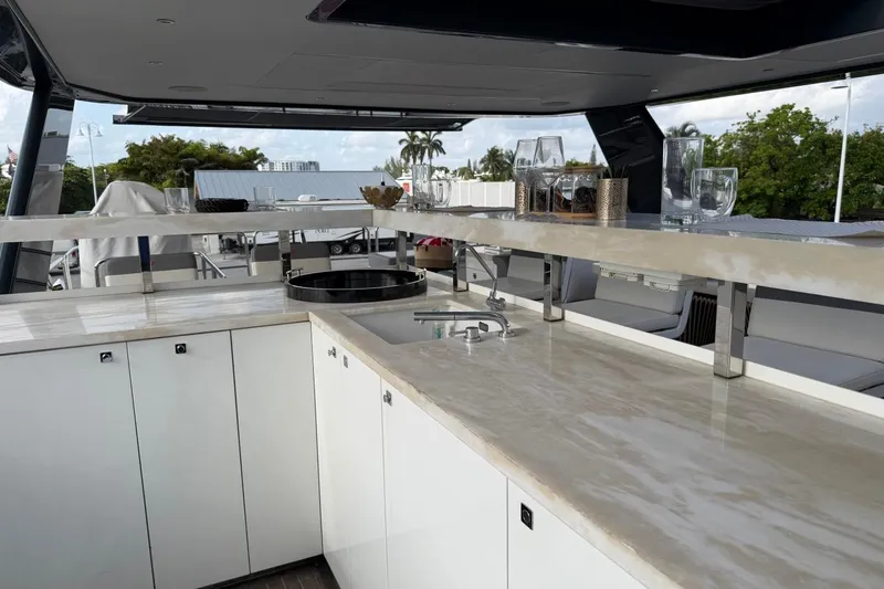 Slide: The Image of Luxurious 2024 Sirena 88 yacht interior with sleek countertops and modern bar setup. - 32
