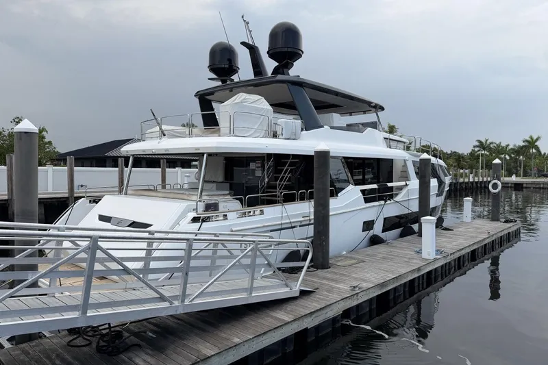 Slide: The Image of Luxury 2024 Sirena 88 yacht docked at marina, showcasing sleek design and modern features. - 2