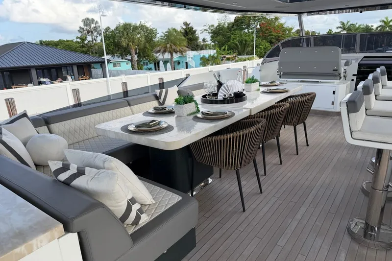 Slide: The Image of Luxurious 2024 Sirena 88 yacht deck with elegant dining setup and modern seating. - 30