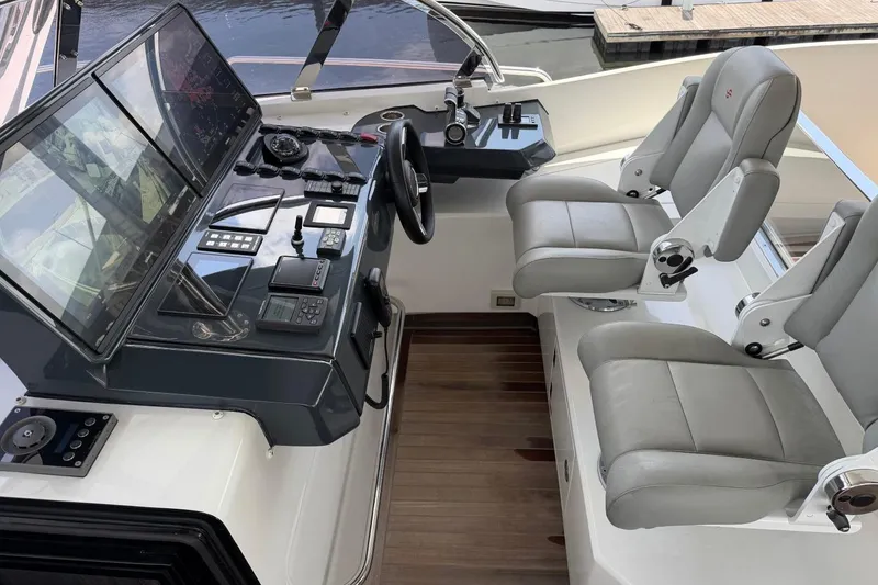 Slide: The Image of Cockpit of 2024 Sirena 88 yacht with modern controls and dual leather seats. - 9