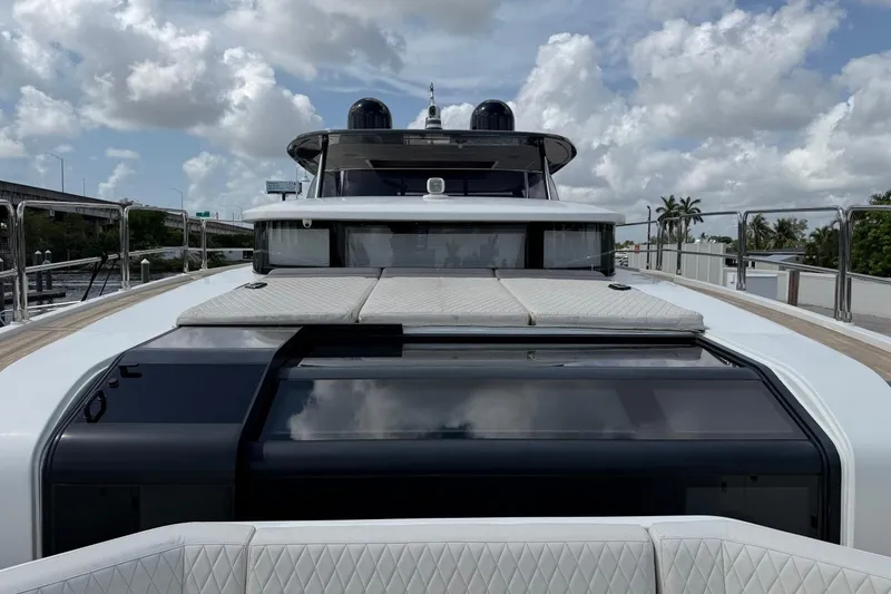 Slide: The Image of 2024 Sirena 88 yacht deck with luxurious seating and sleek design under cloudy sky. - 95