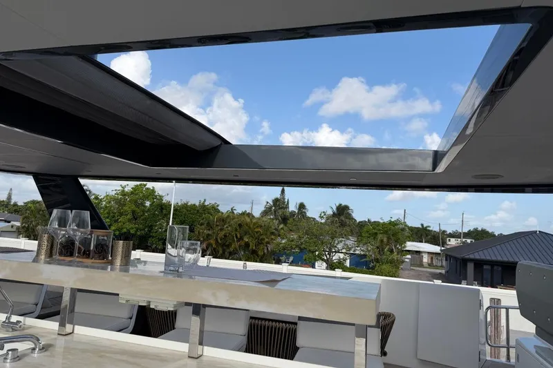 Slide: The Image of Luxurious Sirena 88 yacht interior with open skylight, showcasing elegant dining area, 2024 model. - 33