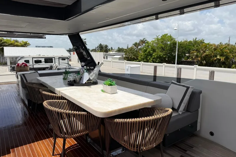 Slide: The Image of Luxurious outdoor dining area on 2024 Sirena 88 yacht with elegant seating and table. - 12