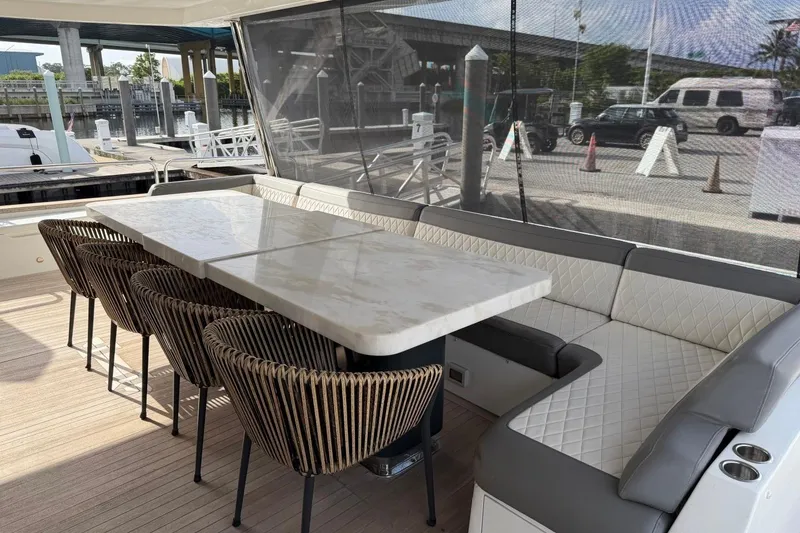 Slide: The Image of Outdoor dining area on 2024 Sirena 88 yacht with elegant seating and marble table. - 90