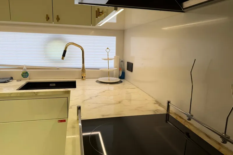 Slide: The Image of Modern kitchen interior of 2024 Sirena 88 yacht with marble countertops and sleek fixtures. - 154