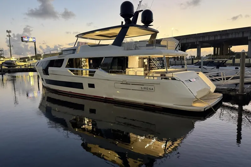 Slide: The Image of Luxurious 2024 Sirena 88 yacht docked at sunset, reflecting on calm water. - 62