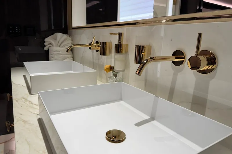 Slide: The Image of Luxurious bathroom with gold fixtures and modern sinks on Sirena 88 yacht, 2024 model. - 75