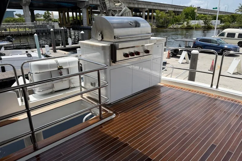 Slide: The Image of Deck of 2024 Sirena 88 yacht featuring a sleek grill and polished wood flooring. - 40