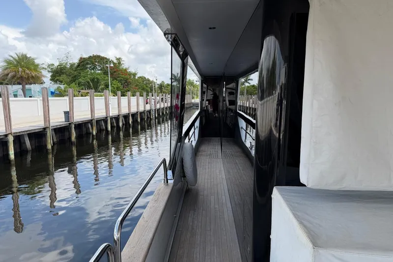 Slide: The Image of Side deck view of 2024 Sirena 88 yacht docked by a wooden pier. - 121