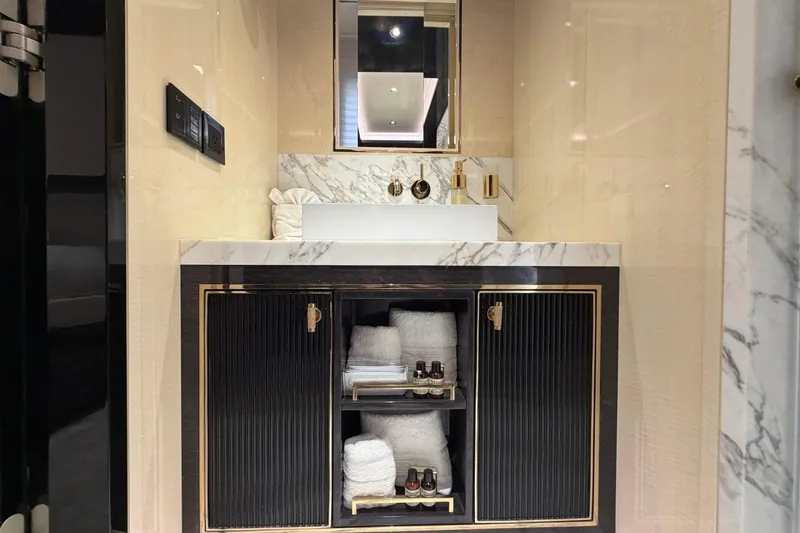 Slide: The Image of Luxurious bathroom vanity on Sirena 88 yacht, featuring marble countertop and elegant storage. - 81