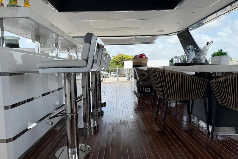 Slide: The Image of Luxurious 2024 Sirena 88 yacht interior with sleek bar stools and elegant dining area. - 50