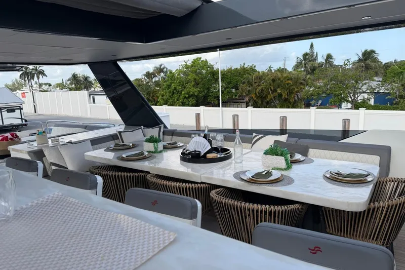 Slide: The Image of Luxurious dining area on 2024 Sirena 88 yacht, featuring elegant table settings and modern decor. - 31