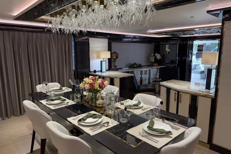 Slide: The Image of Luxurious dining area on 2024 Sirena 88 yacht with elegant table setting and chandelier. - 99