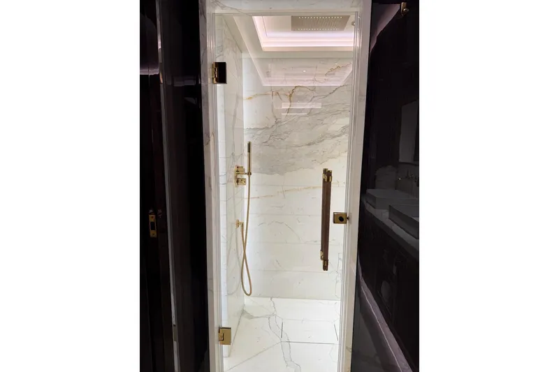Slide: The Image of Luxurious marble shower in 2024 Sirena 88 yacht, featuring elegant gold fixtures. - 74
