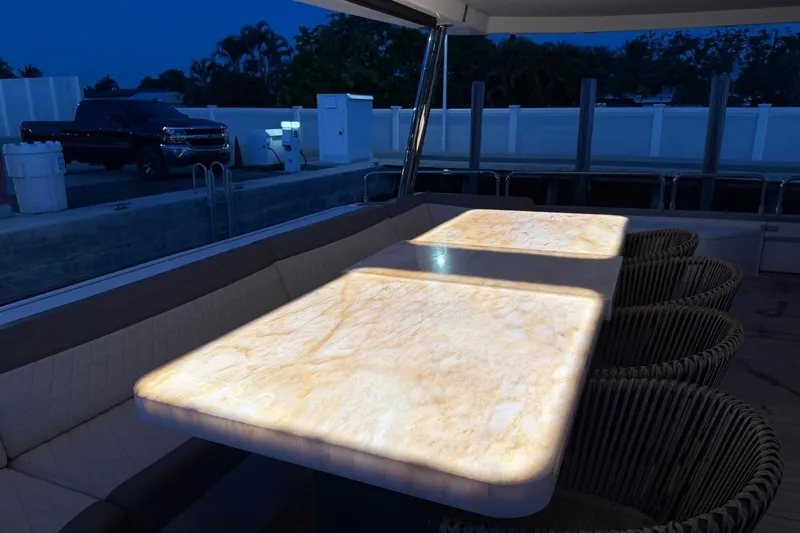 Slide: The Image of Luxurious Sirena 88 yacht deck with illuminated marble table, 2024 model. - 57