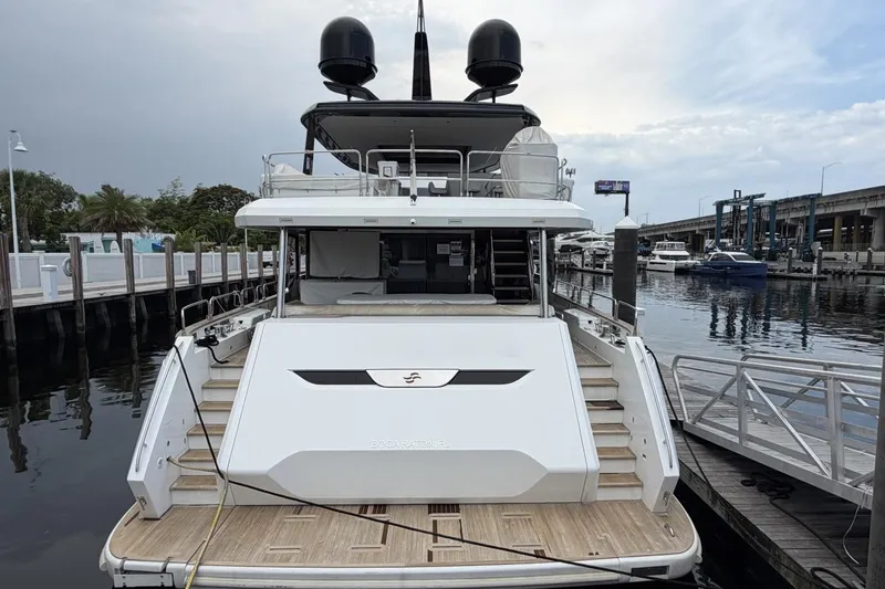 Slide: The Image of 2024 Sirena 88 yacht docked at marina, showcasing sleek design and spacious deck. - 5