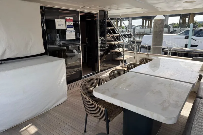 Slide: The Image of Luxurious 2024 Sirena 88 yacht deck with elegant seating and dining area. - 91